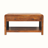 Chunky coffee table, rectangle shaped with curved edges made from a dark brown wood. 