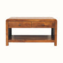 Chunky coffee table, rectangle shaped with curved edges made from a dark brown wood. 