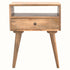 Square wooden bedside table in a light, natural finish, with one drawer, one open shelf and tapered legs. 