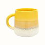 Mug with handle in yellow reactive glaze finish and dipped white stoneware effect.