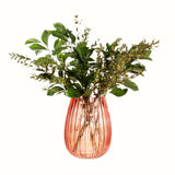 Amber Glass Fluted Vase with a green plant arrangment in. 